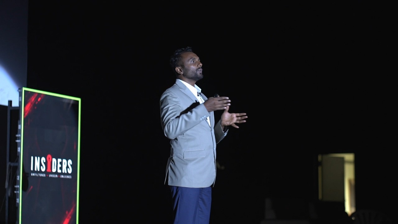 Nikhil Padala giving a TEDx talk